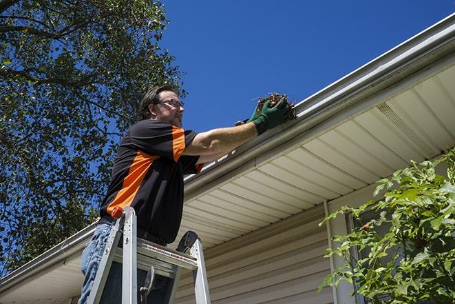 a skilled technician repairing a gutter system in Milan